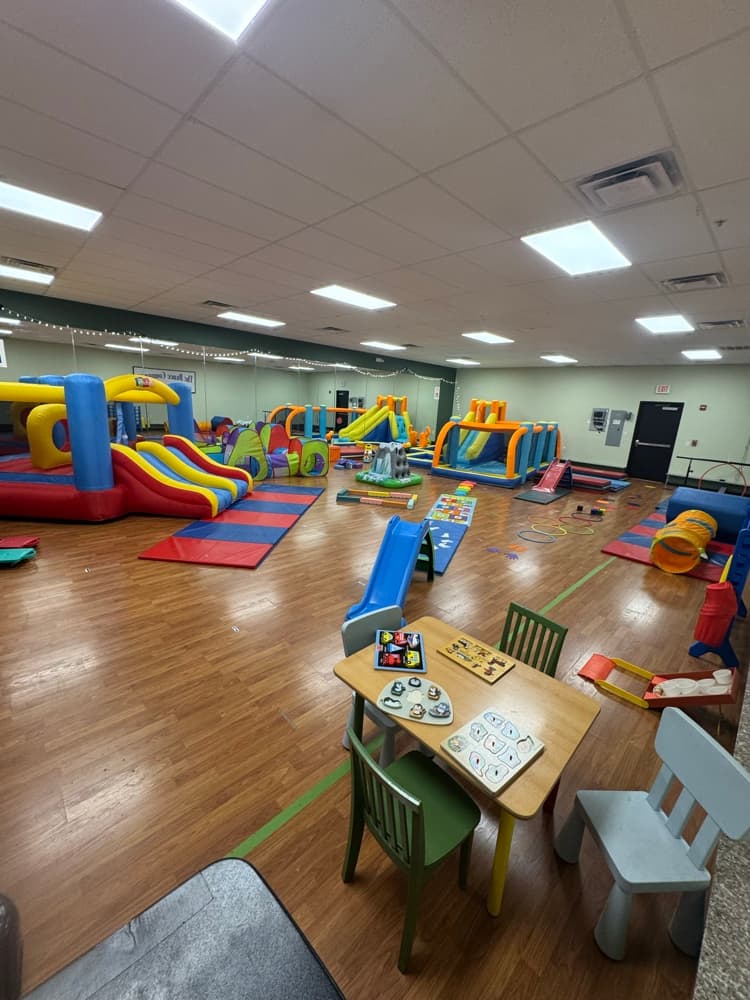 The Wiggle Weekdays play space with bounce houses, slides, and activity stations